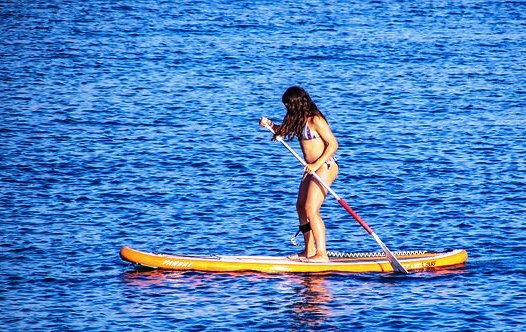 Image of can you paddle board on a surfboard
