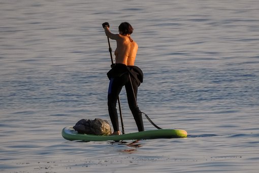 Image of stand up paddle boarding with dry bag